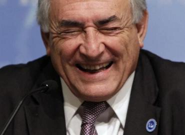 International Monetary Fund (IMF) Managing Director Dominique Strauss-Kahn laughs at a news conference during the spring IMF-World Bank meeting at the IMF headquarters April 24, 2010.  